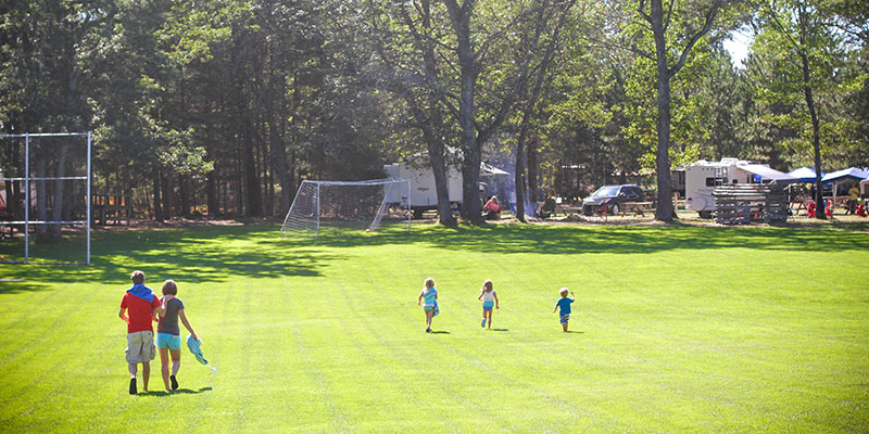 Family on the ballfield at Family Camp